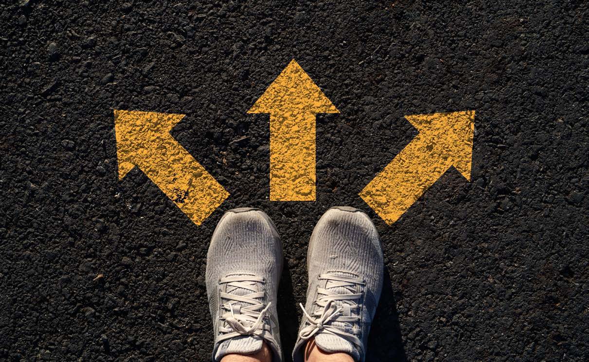 Shoes facing three yellow arrows pointing in different directions.
