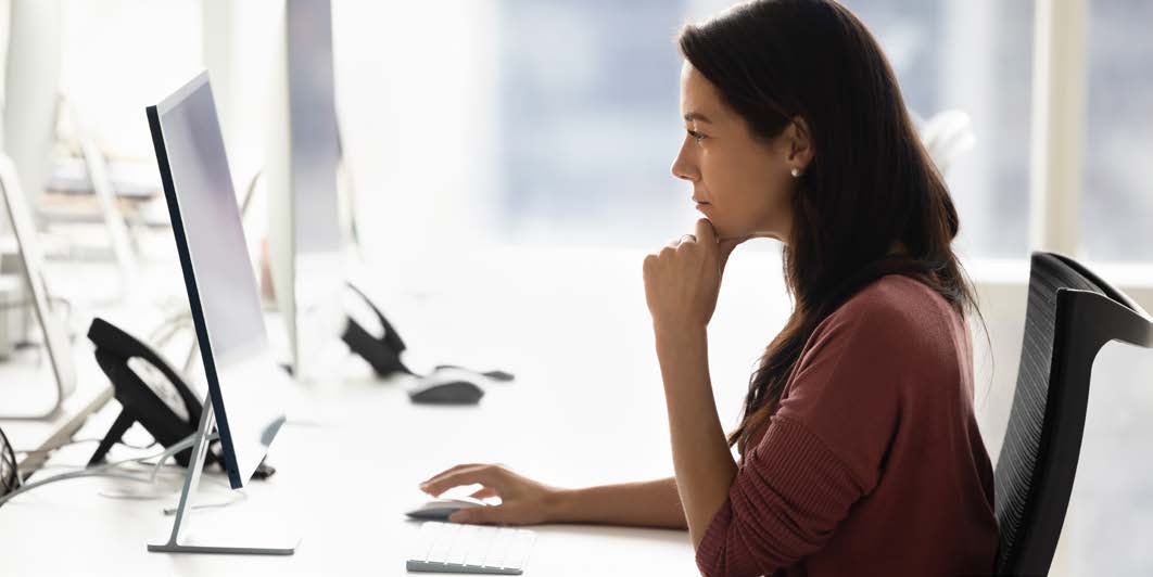 Customer service professional working at a desktop computer.