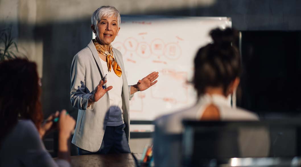 A leader presenting to colleagues in a meeting.
