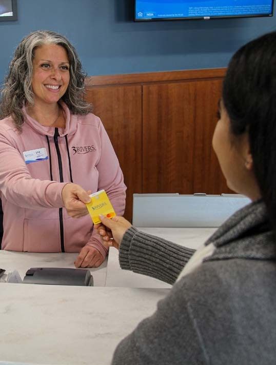 A 3Rivers employee helping a member at a branch.