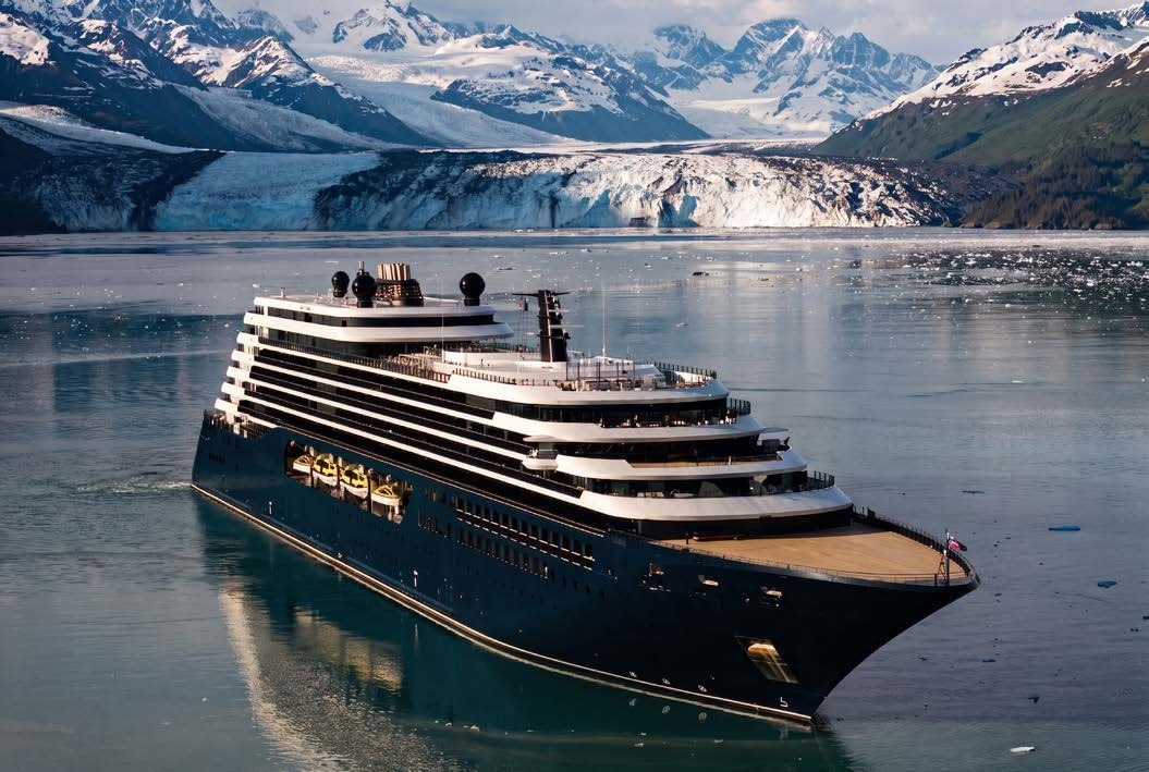 A Ritz-Carlton yacht surrounded by mountains and a glacier