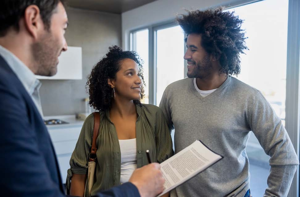 Homebuyers speaking with a real estate professional