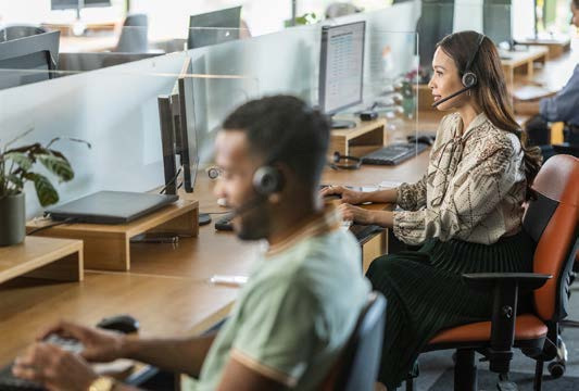 Customer service specialists working at their desks
